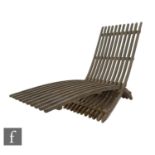 Skargaarden - A folding slatted teak Nozib outdoor lounger of cantilever design, in a weathered