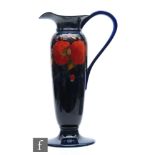 William Moorcroft - A large pedestal ewer decorated in the Pomegranate pattern with fruit and