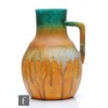 Ruskin Pottery - A crystalline glaze flower jug decorated in bands of green to orange to pale blue