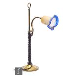 Unknown - An early 20th Century brass desk light with a rise and fall curved neck supporting a