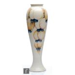 William Moorcroft - A vase of slender tapering form decorated in the Salt Glazed Wisteria pattern,