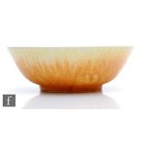 Ruskin Pottery - A high sided bowl decorated in a yellow to green over orange, the exterior in