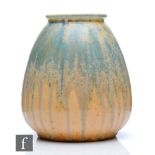 Ruskin Pottery - A squat vase decorated in blue over pale orange crystalline glaze with blue