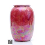 Ruskin Pottery - A vase of swollen form decorated in a Strawberry Crush mottled pink, impressed mark