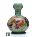 William Moorcroft - A double gourd vase decorated in the Pomegranate pattern with a band of open and