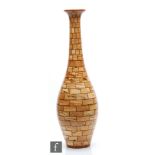 Bill Robinson - A contemporary segmented woodturned vase of ovoid form with tall collar neck and