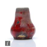 Ruskin Pottery - A miniature high fired vase of globe and shaft form decorated in a tonal flambe