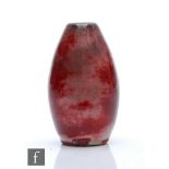 Ruskin Pottery - A miniature high fired vase of swollen barrel form decorated in a tonal flambe