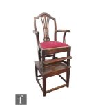 An early 20th Century Hepplewhite style mahogany child's correction chair with foot rail and