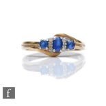 A 9ct hallmarked sapphire and diamond seven stone ring, three sapphires spaced by diamonds all to