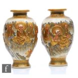 A pair of Japanese Meiji (1868-1912) period satsuma vases, each relief moulded with depictions of