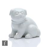 A Japanese Meiji period (1868-1912) Hirado white glazed model of a seated puppy, height 10cm,
