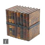 A Huntley & Palmers biscuit tin in the form of eight books, bound with a metal strap below an