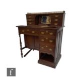 A Victorian mahogany knee hole desk, the brass gallery back above six short drawers centered by a