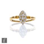 An early 20th Century diamond marquise shaped cluster ring comprising twelve stones to ribbed