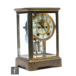 An early 20th Century brass cased Ansonia mantle clock, the dial, gong and mercury filled pendulum