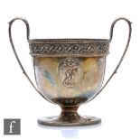 A George III two handled pedestal cup, with beaded and scroll work band decoration above raised