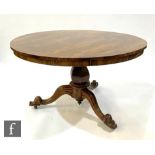 A 19th Century circular rosewood tilt top breakfast table over a shaped pedestal terminating in