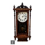 A late 19th Century marquetry inlaid wall clock, painted dial over a glazed door and scroll base,