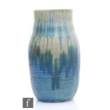 A Ruskin Pottery crystalline vase decorated with a dribble blue over cream with crystalline