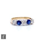 A 9ct hallmarked cubic zirconia and sapphire five stone ring, alternate stones to plain shoulders,
