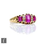 An early 20th Century ruby and diamond seven stone boat shaped ring, three rubies spaced by