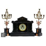 A Victorian slate mantle clock of architectural form and a pair of associated gilt metal four branch