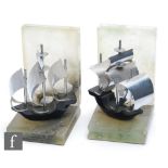 A pair of 1930s Art Deco bookends, each with a stylised ship in full sail, the body enamelled in
