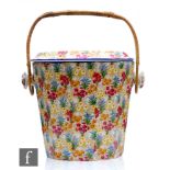 A 1930s Grimwades Chintz slop bucket decorated in the Marguerite pattern, retains original carry