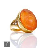 A 19th Century 18ct intaglio carved carnelian ring, oval stone depicting profile of a classical