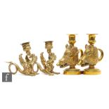 A pair of brass chambersticks modelled as boar's heads, height 14cm, and a similar pair on the