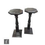 A pair of  black painted early 20th Century jardiniere stands or torcheres of octagonal form, raised