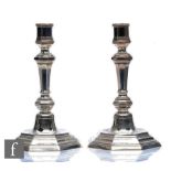 A pair of early 20th Century stepped octagonal shaped candlesticks with knopped columns, height
