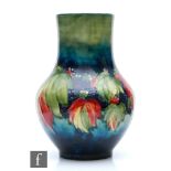 A large Moorcroft vase of globe and shaft form decorated in the Leaf and Blackberry pattern,