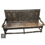 A late 18th and early 19th Century and later constructed quadruple panelled back dark oak settle,