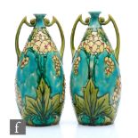 A pair of early 20th Century Minton Seccessionist vases of bottle form with angular handles to the