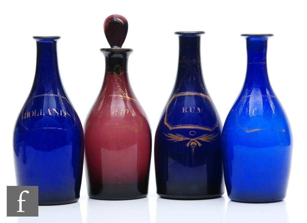 A small collection of late 18th Century decanter bottles each of skittle form, three in Bristol Blue