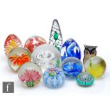 A collection of 20th Century glass paperweights to include Langham, Stuart and Chinese examples with