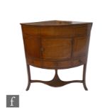 A George IV inlaid mahogany corner washstand with cupboard over splayed legs and a shelf, height