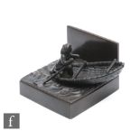 A Japanese Meiji Period (1868-1912), bronze figure of a fisherman in a coracle, stamped character