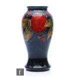 A Moorcroft vase of inverted form decorated in the Pomegranate pattern, impressed signature mark and