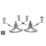 A pair of 1930s Swedish pewter two light candelabra by Ceson, with domed base and lobed finials,