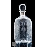 An early 20th Century clear crystal spirit decanter of six sided form, with floral and scroll cut