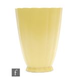 A Wedgwood straw glazed vase designed by Keith Murray, of flared ribbed form, printed KM Wedgwood