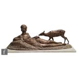 A patinated bronze figure of a reclining woman feeding a deer, signed in the cast D.H. Chiparus, set