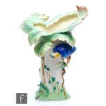 A contemporary Franz porcelain limited edition vase decorated with a parrot perched on a branch, the