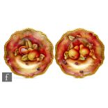 Two Caverswall cabinet plates hand painted by M Bates with pears, strawberries and blackberries,