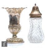 A circular embossed pedestal vase on scroll base, Sheffield 1905, height 13cm, and a silver topped