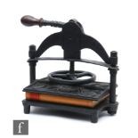 A late 19th Century black painted cast iron book press by Patrick Richie Edinburgh, spoked wheel