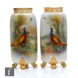 A pair of early 20th Century Royal Worcester shape G42 vases of cylindrical form raised to four